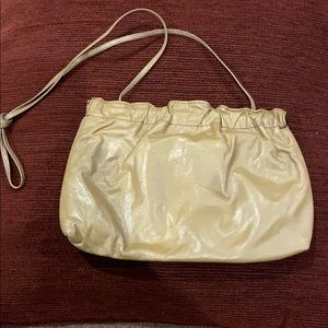 Cute night out tan bag. Flexible “snap” closure.